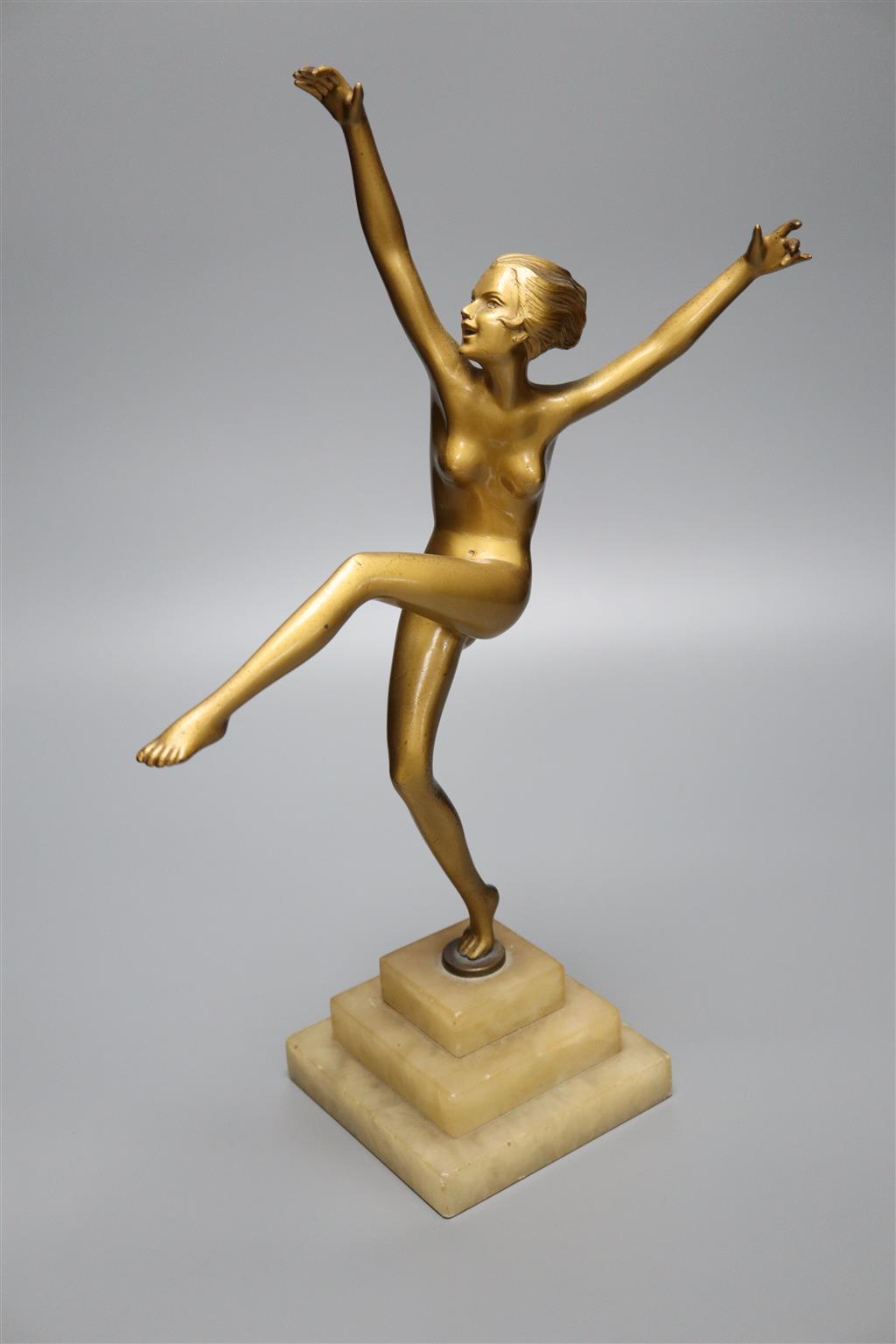 An Art Nouveau bronzed spelter nude dancer, on stepped square alabaster base, 38.5cm